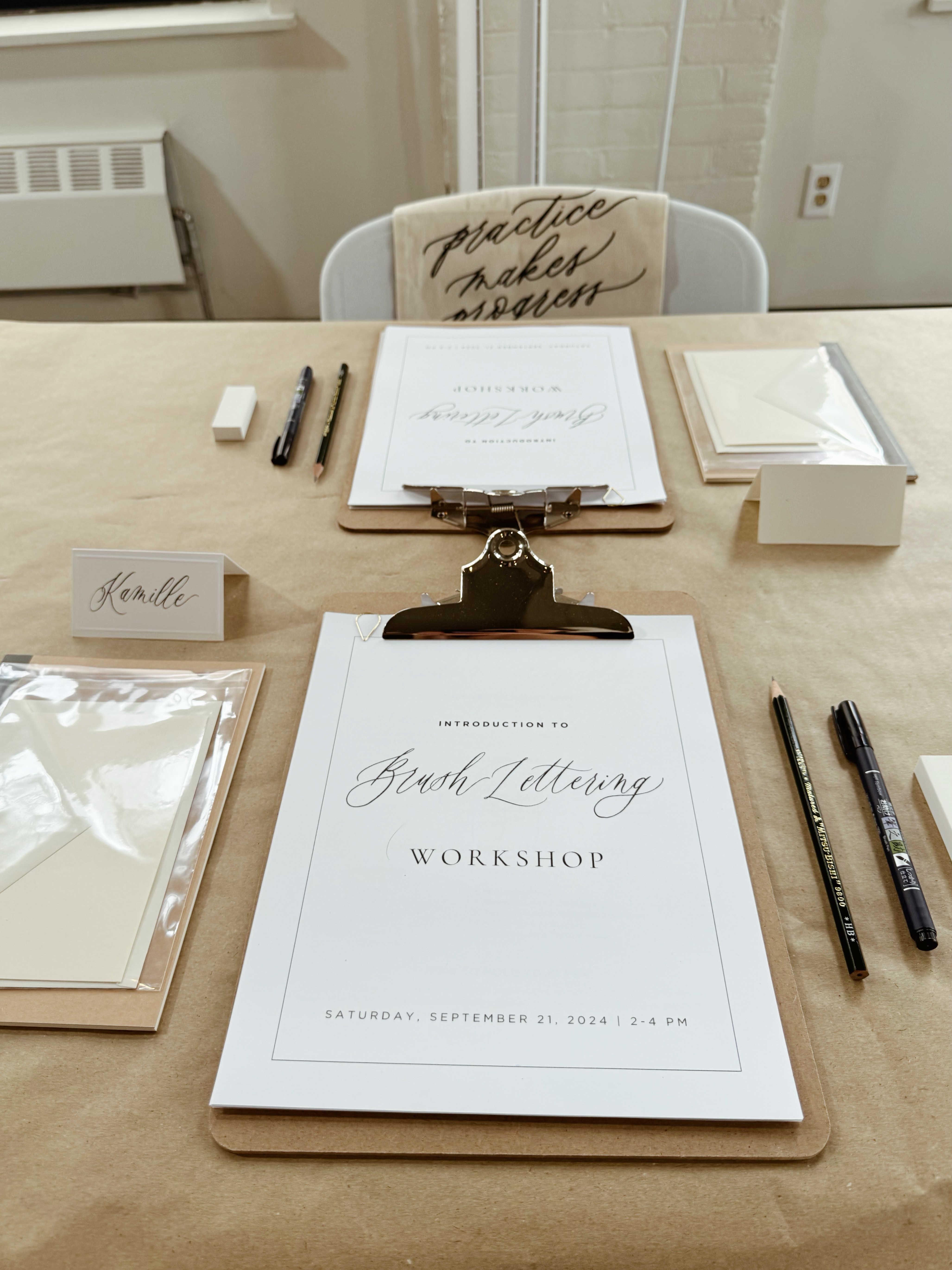 More clipboards with calligraphy material and pen