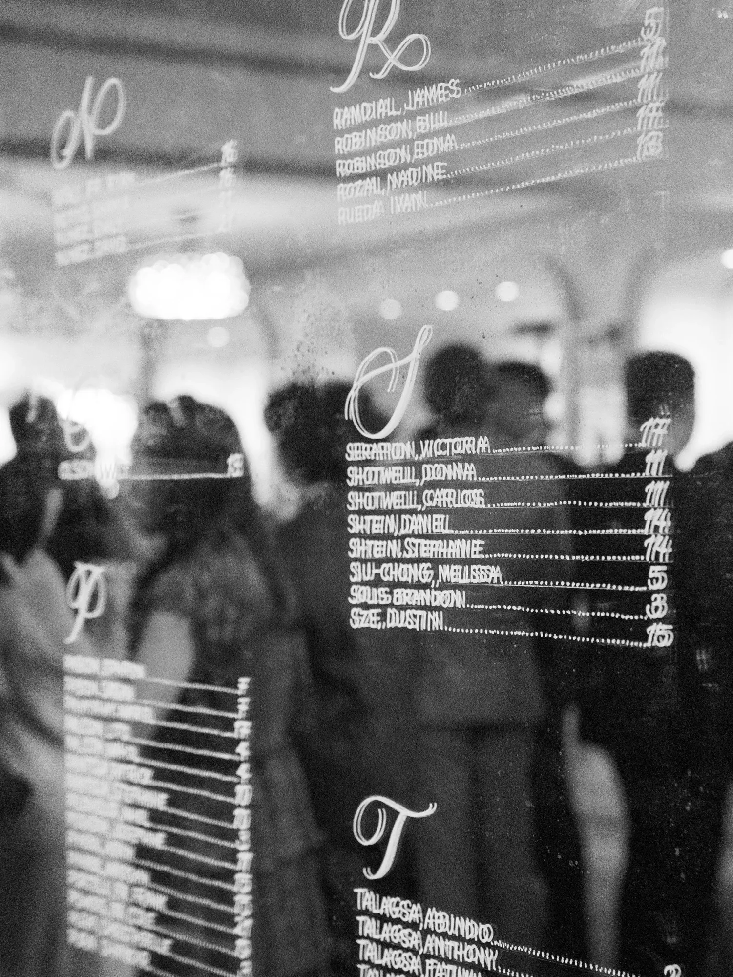 Seating chart in a mirror with custom calligraphy